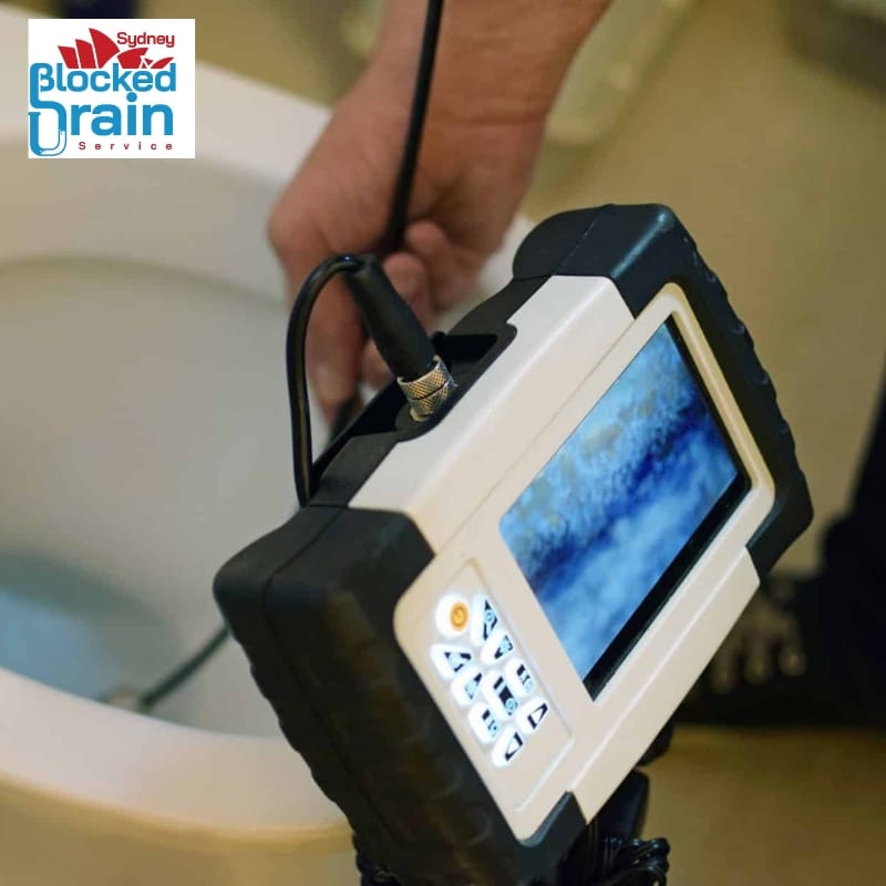 Drainer running an inspection camera into a drain to find what is causing the blockage before anything is cleared