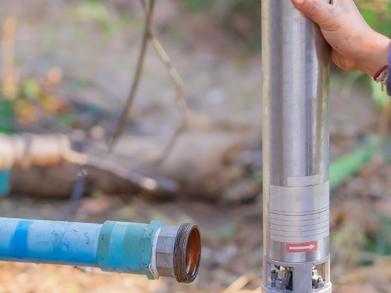 Worker preparing to connect fitting during relining water pipes.