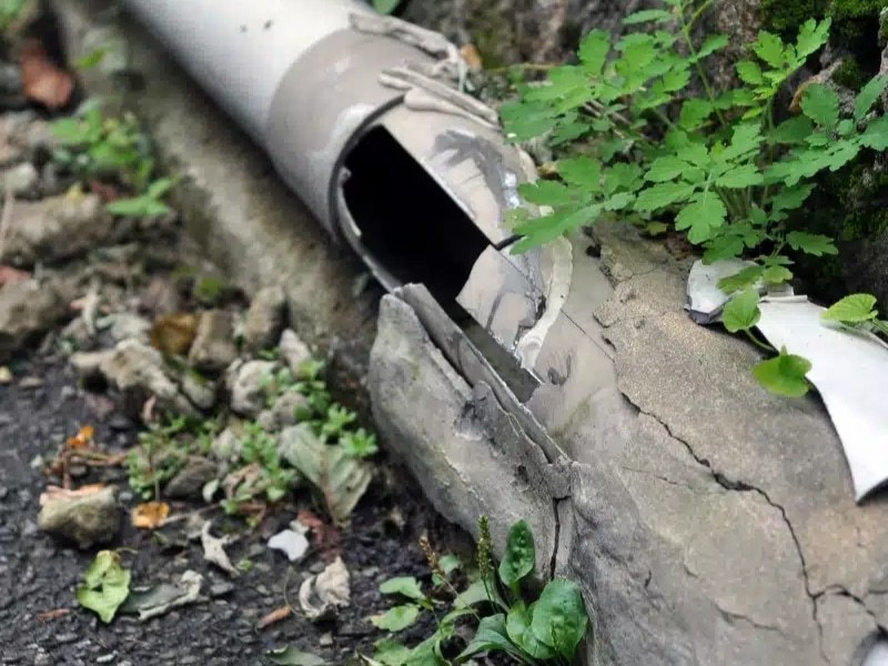 Damaged outdoor pipe showing cracks that require relining water pipes.