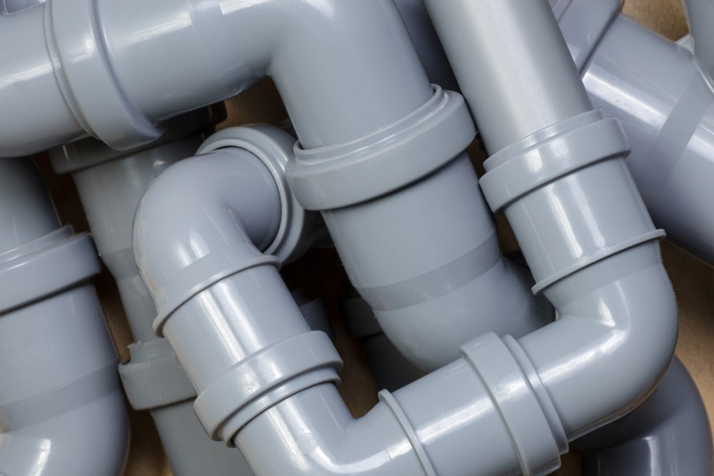 Grey PVC drainage pipes and fittings joined together in a run of bends and junctions