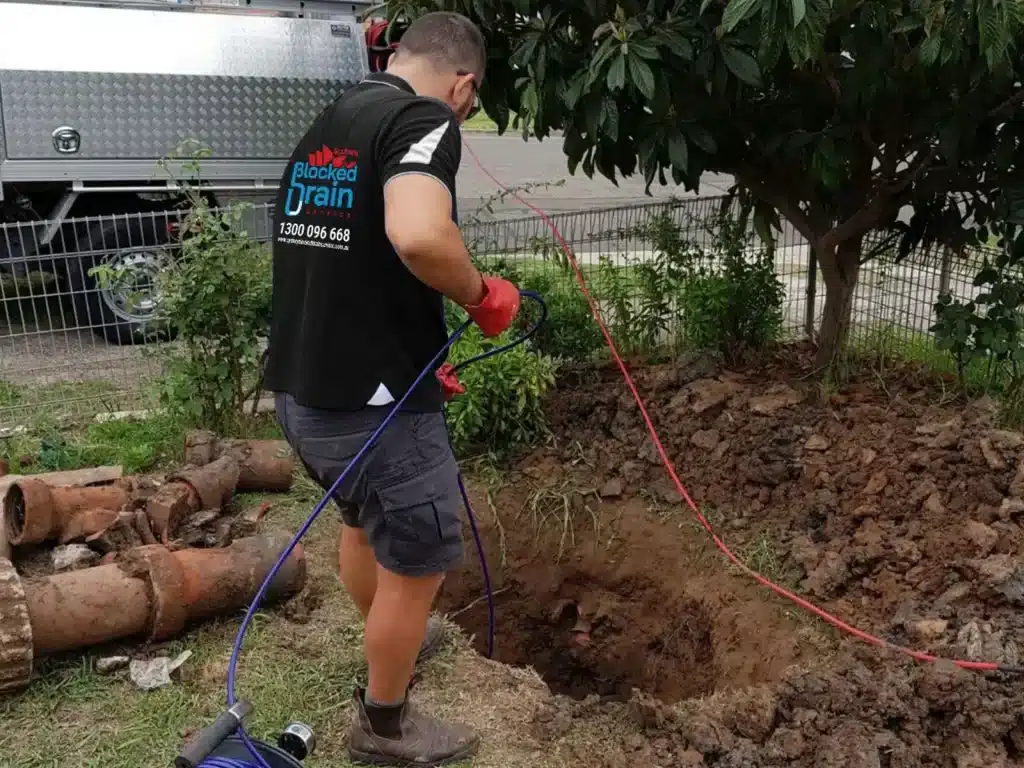 Blocked drains near me in Sydney: licensed plumber using CCTV drain camera to locate a blockage.