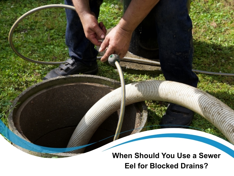 Worker preparing sewer eel equipment at an outdoor drain opening in Sydney.