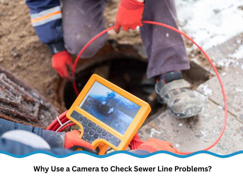 Worker using handheld monitor and camera to check sewer line for blockages underground.